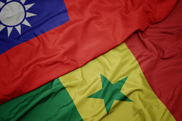 waving colorful flag of senegal and national flag of taiwan.
