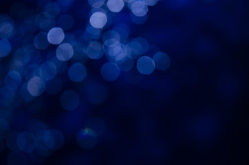 Abstract pattern of blue bokeh garland lights on a dark background