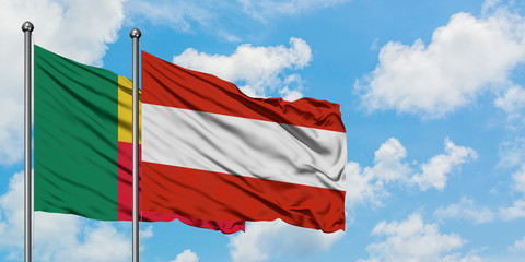 Benin and Austria flag waving in the wind against white cloudy blue sky together. Diplomacy concept, international relations.