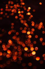 Abstract pattern of red bokeh garland lights on a dark background