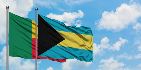 Benin and Bahamas flag waving in the wind against white cloudy blue sky together. Diplomacy concept, international relations.