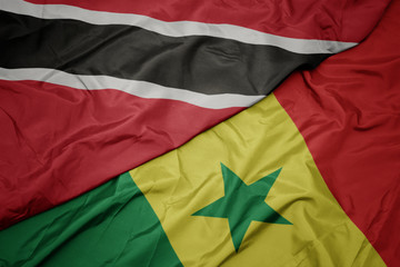 waving colorful flag of senegal and national flag of trinidad and tobago.