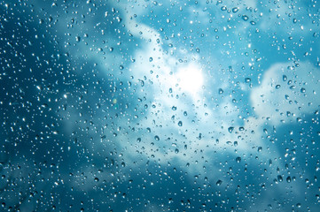 Beautiful sky and clouds, rain, wet glass, drops of water on the glass, drops of water on the...