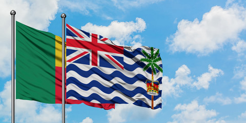 Benin and British Indian Ocean Territory flag waving in the wind against white cloudy blue sky together. Diplomacy concept, international relations.