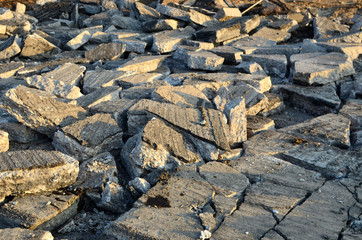Recycling and reuse crushed concrete rubble, asphalt, building material, blocks. Broken concrete slabs at construction site. Сoncrete rubble from demolition at landfill. Hardcore waste recycling