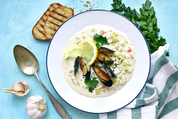 Clam chowder - traditional american soup from sea food with cream or milk. Top view with copy space.