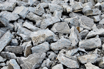 Recycling and reuse crushed concrete rubble, asphalt, building material, blocks. Broken concrete slabs at construction site. Сoncrete rubble from demolition at landfill. Hardcore waste recycling