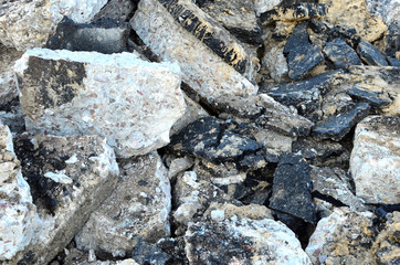 Recycling and reuse crushed concrete rubble, asphalt, building material, blocks. Broken concrete slabs at construction site. Сoncrete rubble from demolition at landfill. Hardcore waste recycling