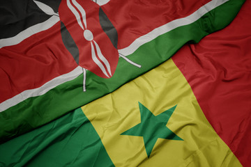 waving colorful flag of senegal and national flag of kenya
