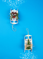 Sleigh with Christmas tree on blue background. Christmas background. Christmas card.