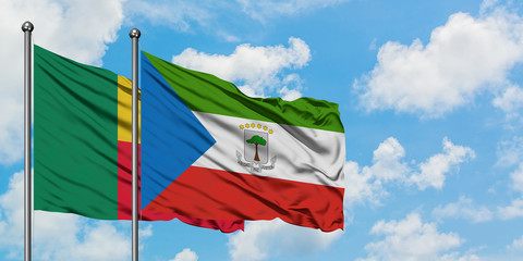 Benin and Equatorial Guinea flag waving in the wind against white cloudy blue sky together....