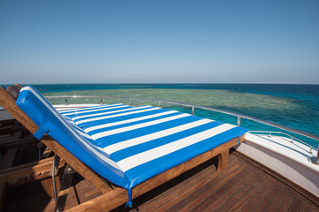 Sun loungers on the bow of a large luxury motor yacht