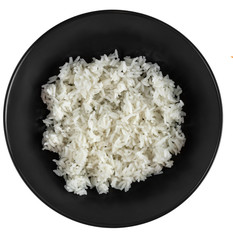 White rice in black matte plate isolated on a white background, top view