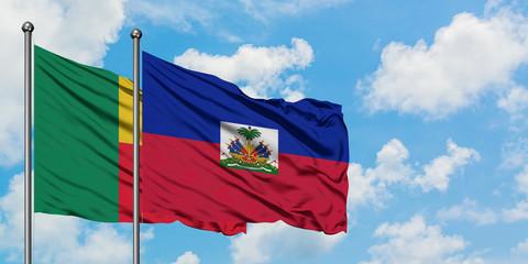 Benin and Haiti flag waving in the wind against white cloudy blue sky together. Diplomacy concept, international relations.