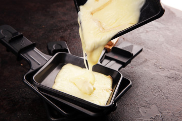 raclette cheese melted served in individual raclette skillets