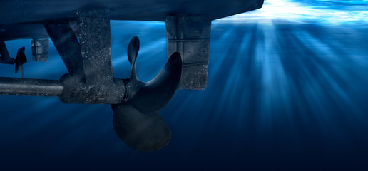 Twin propeller and rudder of big ship underway from underwater. Close up image detail of ship. Transportation industry. Freight transportation.
