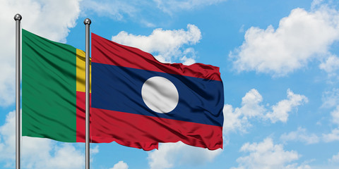 Benin and Laos flag waving in the wind against white cloudy blue sky together. Diplomacy concept, international relations.
