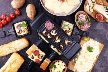 Delicious traditional Swiss melted raclette cheese on diced boiled or baked potato.