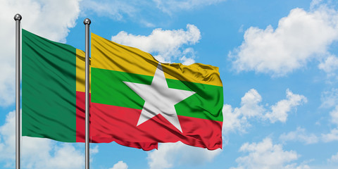 Benin and Myanmar flag waving in the wind against white cloudy blue sky together. Diplomacy concept, international relations.