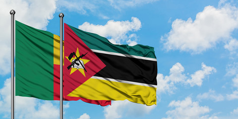 Benin and Mozambique flag waving in the wind against white cloudy blue sky together. Diplomacy concept, international relations.