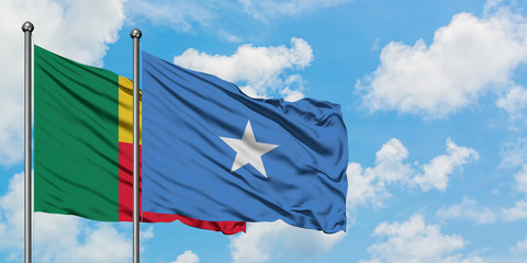 Benin and Somalia flag waving in the wind against white cloudy blue sky together. Diplomacy concept, international relations.