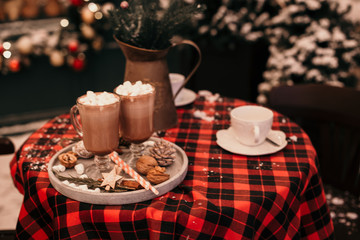 Christmas table decor with cocoa and marshmallows.