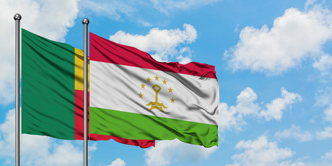 Benin and Tajikistan flag waving in the wind against white cloudy blue sky together. Diplomacy concept, international relations.