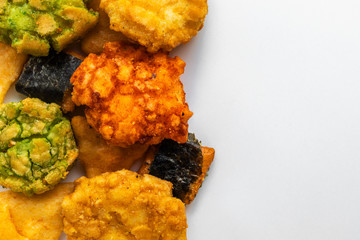 Japanese snacks with seaweed and wasabi lie on the left on a white background, on the right is an empty place
