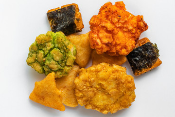 Japanese snacks with seaweed and wasabi lie in the center on a white background