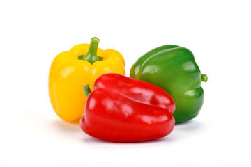Three perfect bell peppers isolated on a white background in close-up (high details)