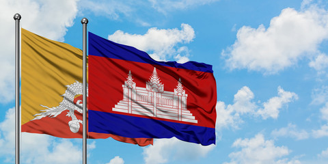 Bhutan and Cambodia flag waving in the wind against white cloudy blue sky together. Diplomacy concept, international relations.