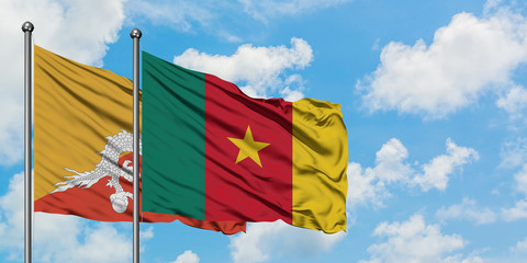 Bhutan and Cameroon flag waving in the wind against white cloudy blue sky together. Diplomacy concept, international relations.
