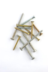  golden and silver screws lying on top of each other on a white background.vertical orientation.Flat lay 