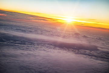 Fototapeta na wymiar Sunset sky with beautiful clouds from the airplane window