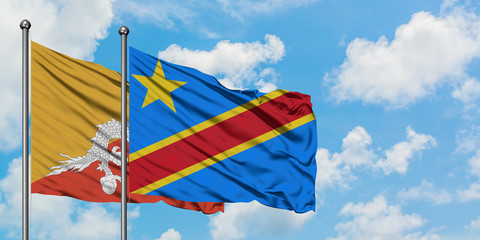 Bhutan and Congo flag waving in the wind against white cloudy blue sky together. Diplomacy concept, international relations.