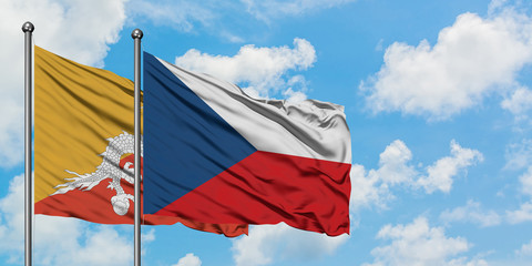 Bhutan and Czech Republic flag waving in the wind against white cloudy blue sky together. Diplomacy concept, international relations.