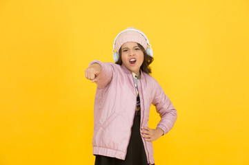 Hey you. Little girl pointing finger. Small child pointing yellow background. Pointing gesture as nonverbal communication. Pointing at something. Back to school promotion