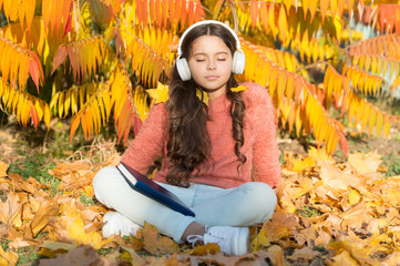 Schoolgirl study. Girl read book autumn day. Self education concept. Child enjoy reading. Visual and audio information. Little child enjoy learning at backyard. Kid study with book. Study every day