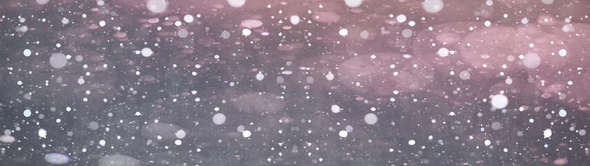snowflakes on dark sky in the night – winter bokeh snowy background panorama banner long