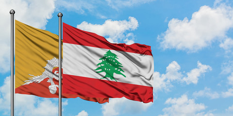 Bhutan and Lebanon flag waving in the wind against white cloudy blue sky together. Diplomacy concept, international relations.