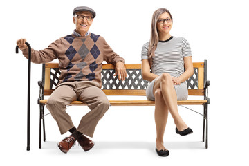 Elderly man and a young woman resting on a bench