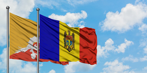 Bhutan and Moldova flag waving in the wind against white cloudy blue sky together. Diplomacy concept, international relations.