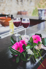 Film photo of a bouquet of flowers and two wine cups