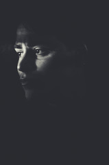 Dark portrait of a man with only his eyes lighted
