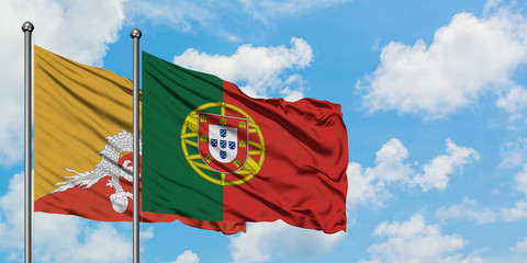 Bhutan and Portugal flag waving in the wind against white cloudy blue sky together. Diplomacy concept, international relations.