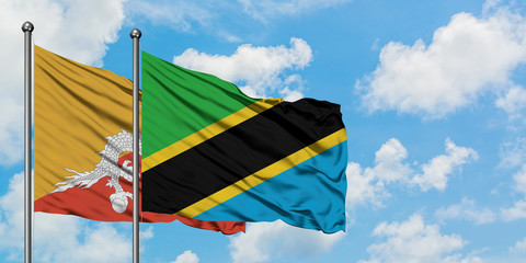 Bhutan and Tanzania flag waving in the wind against white cloudy blue sky together. Diplomacy concept, international relations.