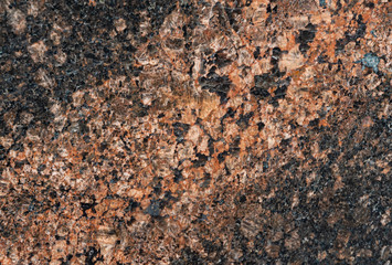 Polished granite as background to any disain. Close up of red marbled granite texture