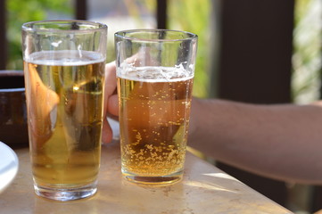 glass of beer on wooden table in a cafe
