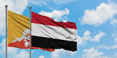 Bhutan and Yemen flag waving in the wind against white cloudy blue sky together. Diplomacy concept, international relations.