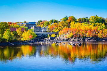 Naklejka premium Autumn Landscape View of Color Trees with Dam on Lake in City Park